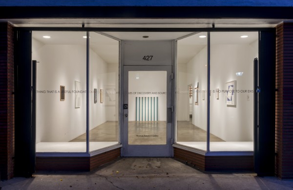 A view of "Architectural Dispositions" from outside the front windows. Photo by Joshua White.