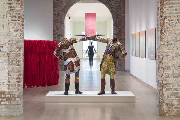 Yinka Shonibare MBE, How to Blow Up Two Heads at Once (Gentleman), 2006; installation view, The Divine Comedy: Heaven, Purgatory, and Hell Revisited by Contemporary African Artists, 2014. Courtesy of SCAD Museum of Art, photo by Marc Newton.