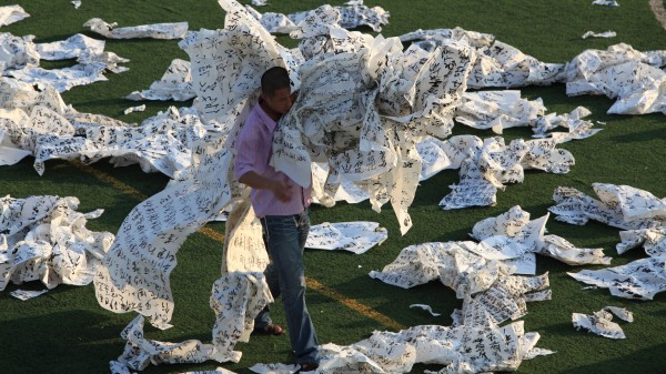 Yangjiang Group, Das Kapital Football (still), 2009, ink on xuan paper calligraphy, action, documentation, installation (two channel video: DV widescreen anamorphic, colour, with sound, ink on xuan paper carpet). Courtesy the artists and Vitamin Creative Space