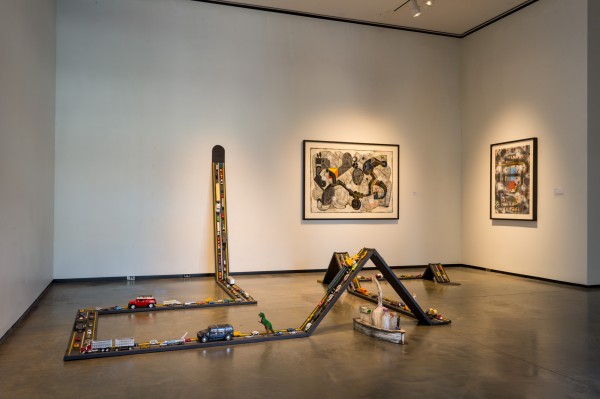 Luis Cruz Azaceta. Installation view of Evacuation-Highway, 2005; toys on wood; dimensions variable. Image courtesy of the Abroms-Engel Institute for the Visual Arts.