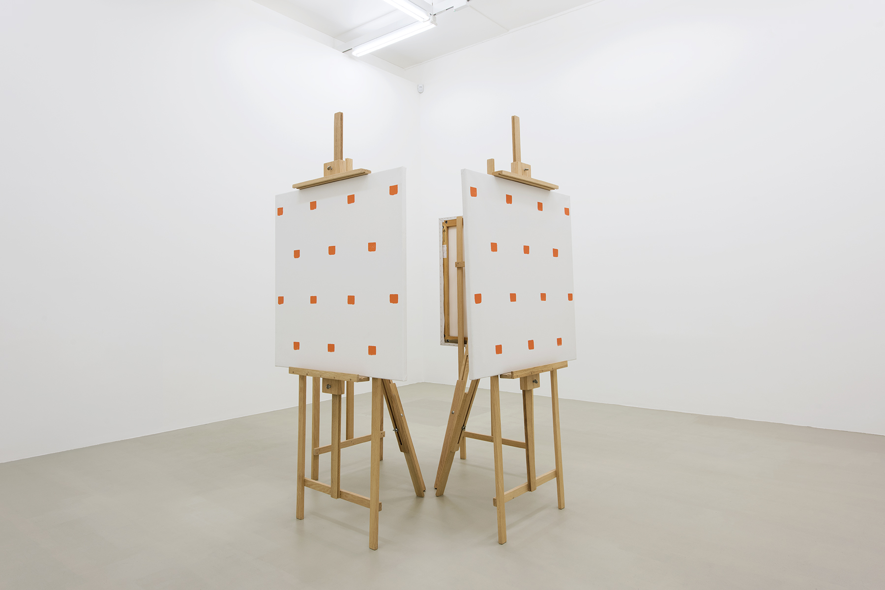 Niele Toroni. Andata E Ritorno (orange), 1991; installation of four canvases, easels – imprints of No 50 brush repeated at regular distances 30 cm; 39 1/2 x 39 1/2 x 1 1/8 in (each). Courtesy  of the Artist and Marian Goodman Gallery, London. Photo: Thierry Bal.